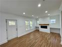 Bright living room with wood floors, a fireplace, and custom shelving at 438 Holly Nw St, Atlanta, GA 30318