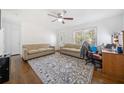 Cozy living room with hardwood floors, featuring two couches and a ceiling fan for added comfort at 717 Chamberlain Sw Cir, Marietta, GA 30008