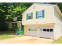 Inviting home featuring a two-car garage and classic siding at 2238 Scarbrough Dr, Stone Mountain, GA 30088