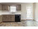 A kitchen with painted cabinets, a black dishwasher, and an exterior door at 116 Shefield Pl, Douglasville, GA 30134