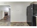 View from kitchen featuring appliances, a fireplace and updated flooring in the connected living area at 116 Shefield Pl, Douglasville, GA 30134