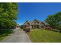 Beautiful stone and brick home with a long, private driveway on a manicured lawn at 20 Rivercreek Xing, Kingston, GA 30145