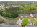 Aerial view of townhouses nestled in a wooded community with lush trees and landscaping at 3355 Waldrop Trl, Decatur, GA 30034