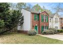 Charming two-story brick townhouse with green shutters and a well-maintained side yard at 3355 Waldrop Trl, Decatur, GA 30034
