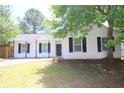Charming single-story home with a black roof, black shutters, and a well-maintained front yard at 6269 Marbut Farms Rd, Lithonia, GA 30058