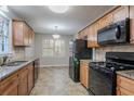 Well-lit kitchen with stainless steel appliances, granite countertops and tile backsplash at 3094 Calumet Nw Cir, Kennesaw, GA 30152