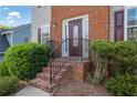 Close up of the front entrance with brick steps and wrought iron railing at 4005 Saddlebrook Creek Dr, Marietta, GA 30060