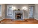 Living room featuring hardwood floors, fireplace with mantle, and neutral gray paint at 605 Harold Ne Ave, Atlanta, GA 30307