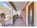 Cozy front porch with a classic porch swing, brick siding, and an inviting entrance at 105 Ruff Harris Dr, Dallas, GA 30157