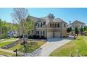A stately two-story home with attached garage and manicured lawn shows great curb appeal at 302 Grant Ct, Canton, GA 30114