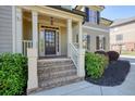 Inviting front porch with brick stairs, white columns, and lush landscaping welcomes you home at 302 Grant Ct, Canton, GA 30114