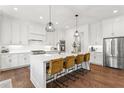 Bright kitchen features white cabinets, stainless steel appliances and a large island with seating at 1291 Briarwood Ne Rd, Brookhaven, GA 30319