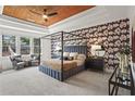 Spacious main bedroom with a striking accent wall, wood ceiling and ample natural light at 1291 Briarwood Ne Rd, Brookhaven, GA 30319