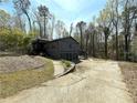 Two-story home with gray siding, a two-car garage, and a landscaped front yard surrounded by mature trees at 2919 Manitoba Ln, Marietta, GA 30062