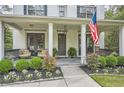 Inviting front porch with rocking chairs, potted plants, and a view of the well-maintained garden at 555 E Wesley Ne Rd, Atlanta, GA 30305