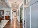 Long hallway with hardwood floors, gray walls, detailed ceiling, and an open doorway at 555 E Wesley Ne Rd, Atlanta, GA 30305