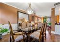 Classic dining room featuring glass table, upholstered chairs, hardwood flooring, and decorative accents at 1920 Barrington Dr, Jonesboro, GA 30236