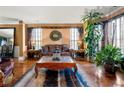 Elegant living room with hardwood floors, decorative rug, large windows with natural light, and stylish decor at 1920 Barrington Dr, Jonesboro, GA 30236