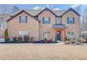 Lovely two-story house showcasing a brick exterior, tidy landscaping, and a covered front entry at 806 Relic Rdg, Hampton, GA 30228