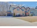Spacious home featuring a brick facade, attached garage, and expansive driveway in a quiet neighborhood at 806 Relic Rdg, Hampton, GA 30228