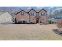 Inviting brick-front home with a manicured lawn and inviting entryway, creating a welcoming curb appeal at 806 Relic Rdg, Hampton, GA 30228