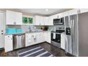 Well-lit kitchen with stainless steel appliances, white cabinets, granite countertops and a window view at 1094 Regent Sw St, Atlanta, GA 30310