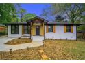 Charming home with a manicured lawn, brick facade, and stylish wood accents at 1934 Pinedale Pl, Decatur, GA 30032