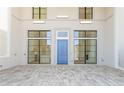 This covered outdoor space features a blue front door, tile floor, and windows on either side at 260 Guild Ln, Fayetteville, GA 30214