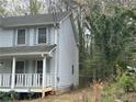 Side view of a two-story home, showing its architectural details at 4481 Dunmovin Nw Dr, Kennesaw, GA 30144