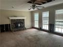 Living room with a stone fireplace and natural light at 4481 Dunmovin Nw Dr, Kennesaw, GA 30144