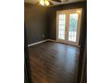 Bedroom featuring a hardwood floor, and double doors that lead to the outside at 6434 Wellington Chase Ct # 6434, Lithonia, GA 30058