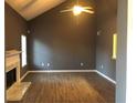 Bright living room featuring wood floors, fireplace, high ceilings, and a ceiling fan at 6434 Wellington Chase Ct # 6434, Lithonia, GA 30058