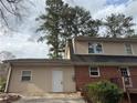 The home's rear exterior features a neutral siding with an access door at 1606 King Rd, Riverdale, GA 30296