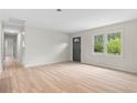 Bright living room featuring wood-look floors, gray front door, and windows providing natural light at 1958 Calvary Hill Sw Ct, Marietta, GA 30008