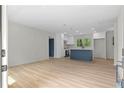 Open-concept living room and kitchen with white cabinets and a contrasting blue island at 1958 Calvary Hill Sw Ct, Marietta, GA 30008