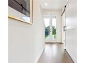 Bright hallway with a white barn door, light wood floors, and a view to the backyard at 2029 Memorial Dr # 32, Atlanta, GA 30317