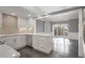 Open-concept kitchen with stainless appliances, marble counters, and view to dining room with natural light at 2769 Peachtree Ne Rd # 10, Atlanta, GA 30305
