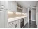 Kitchenette features white cabinets, marble countertops, wine cooler, and under-cabinet lighting at 2769 Peachtree Ne Rd # 10, Atlanta, GA 30305