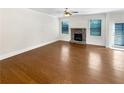 Spacious living room showcasing hardwood floors, a stone fireplace, and ample natural light for a welcoming space at 3305 Pleasant Manor Ct, Cumming, GA 30028