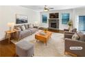 Cozy staged living room featuring stone fireplace, hardwood floors, and neutral tones for a warm and inviting atmosphere at 3305 Pleasant Manor Ct, Cumming, GA 30028