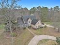Aerial view of a home with mature trees and a circular driveway, showcasing its serene and private setting at 905 Attaway Rd, Bowdon, GA 30108