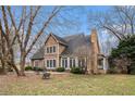 Charming exterior with a brick chimney, a patio for seating, and a sunroom, perfect for enjoying the outdoors at 905 Attaway Rd, Bowdon, GA 30108