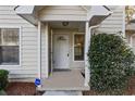 Inviting front entrance with covered porch, decorative door, and manicured landscaping at 164 Adrian Dr, Stockbridge, GA 30281