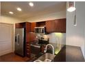Well-equipped kitchen with stainless steel appliances and dark countertops at 390 17Th Nw St # 4037, Atlanta, GA 30363