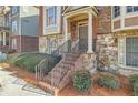 Inviting townhome entrance with brick steps, stone accents, and manicured bushes at 3901 High Dove Sw Way # 17, Smyrna, GA 30082