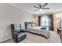 Spacious bedroom with a plush chair, soft carpet, ceiling fan and lots of natural light at 5 Burns View Ct, Lawrenceville, GA 30044