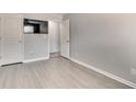 Bright room featuring wood floors, two doors, and a wall-mounted television at 5 Burns View Ct, Lawrenceville, GA 30044