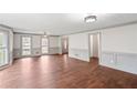 Spacious living room features hardwood floors, fresh paint, and natural light from large windows at 906 John Ct, Lawrenceville, GA 30046