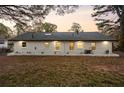 Expansive backyard featuring a freshly painted white brick home with a dark roof at 1970 Capri Dr, Decatur, GA 30032