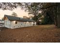 Large backyard featuring a freshly painted white brick home with a dark roof at 1970 Capri Dr, Decatur, GA 30032